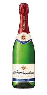 Eine grüne Sektflasche mit rotem Korken, beschriftet mit 'Rotkäppchen' und dem Hinweis auf halbtrockenen Sekt.