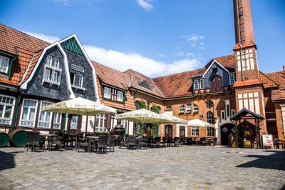 Nordhausen: An inviting courtyard with tables and chairs, surrounded by charming, historic buildings and parasols.