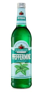 A green bottle of peppermint liqueur with a fresh mint leaf design and clear labeling that emphasizes the refreshing taste.