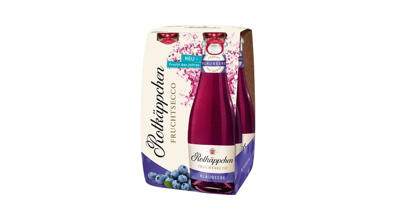 Eine Packung Rotkäppchen Fruchtsecco mit dem neuen Geschmack Blaubeere, umgeben von frischen Blaubeeren.