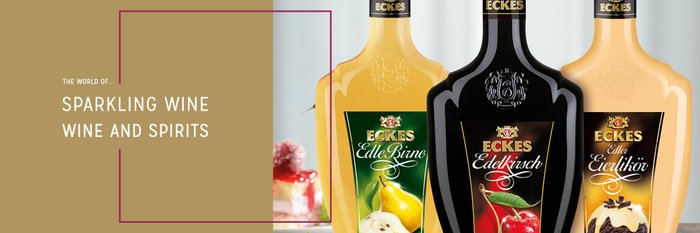 Three bottles of Eckes liqueur in different flavors stand on a table.