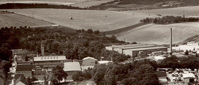 Aerial view of a rural industrial plant with green fields